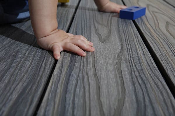 Spliter-free, safe and child friendly composite decking close up of babies hand