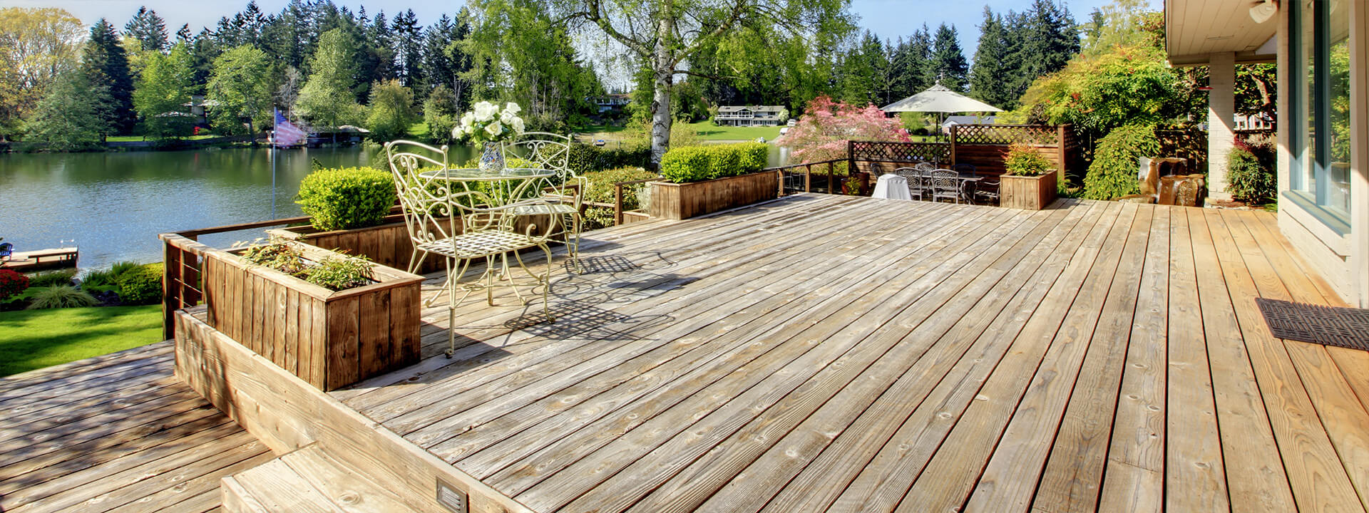 Stock photo of a tired timber decking area overlooking a lake